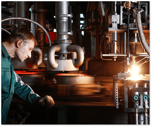 Industrial worker in green overalls working with electrical equipment